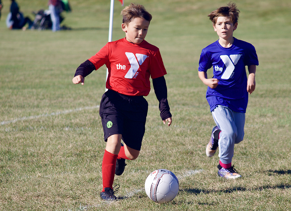 Children compete in YMCA youth soccer programs. 