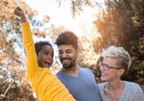 Happy young mixed race couple spending time with their daughter